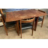 A mid 20th century teak extending dining table on tapering legs together with a set of four teak