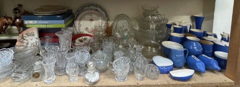 A collection of place name pottery together with glass bowls, drinking glasses, glass vases,