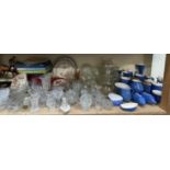 A collection of place name pottery together with glass bowls, drinking glasses, glass vases,