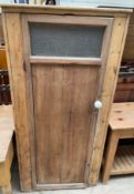 A 19th century pine larder cupboard with a frosted glass panelled door