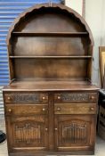 A 20th century oak dresser, the domed rack with two shelves above a rectangular top,