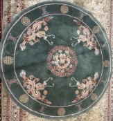 A Chinese rug, of circular form and a green ground decorated with dragons,