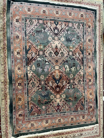 A modern green ground rug decorated with geometric patterns, horses and flowers,