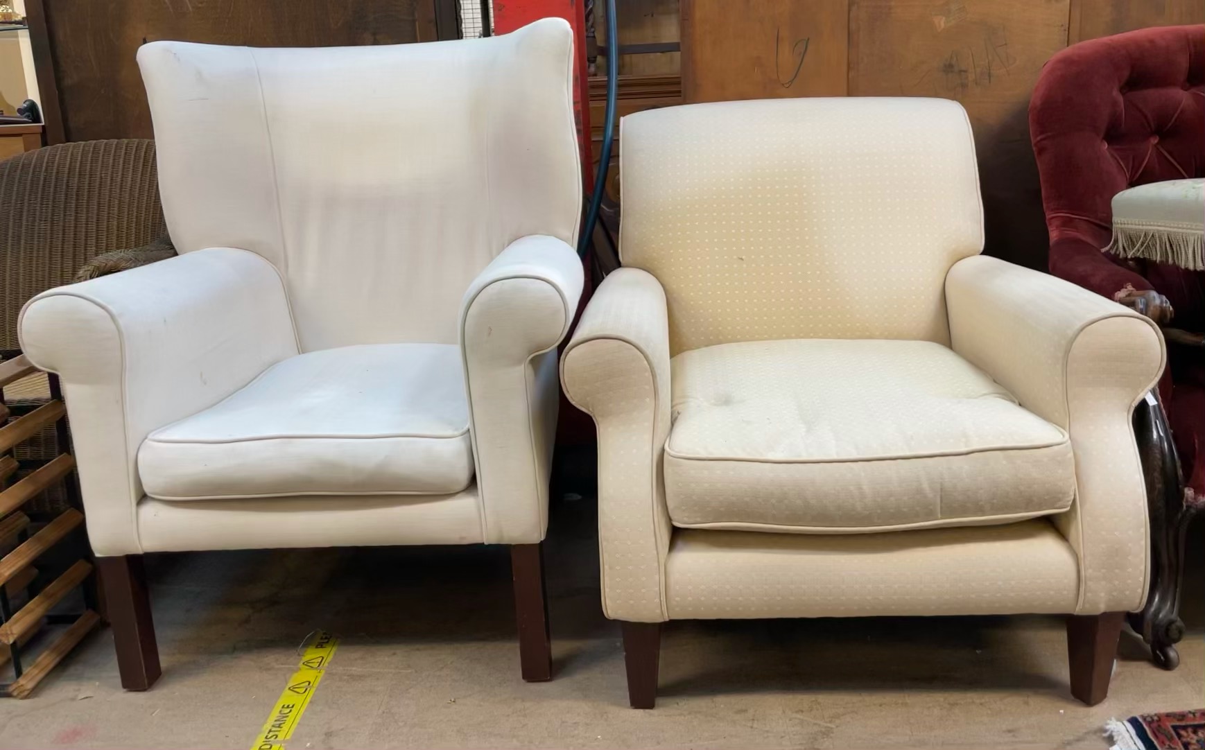 A George III style wing back elbow chair with cream upholstery on square tapering legs together