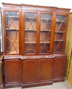 A reproduction mahogany breakfront bookcase, the with a moulded cornice above three astragal doors,