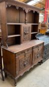A 19th century Low Countries oak dresser, the moulded cornice above a carved frieze,