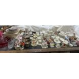 An extensive lot including part tea sets, pottery figures, paperweights, floral baskets,