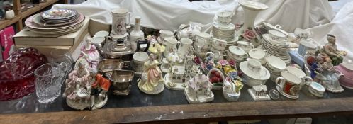 An extensive lot including part tea sets, pottery figures, paperweights, floral baskets,