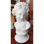 A white painted reconstituted stone head and shoulders portrait bust of a maiden,