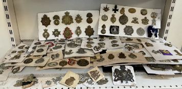 A collection of circa two hundred and fifty military cap badges including East Surrey,