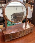 A 19th century mahogany toilet mirror, with oval mirror supported by scrolling uprights,