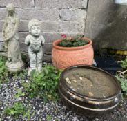 A reconstituted stone figure of a young boy,