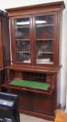 An Edwardian walnut secretaire bookcase, the moulded cornice above a pair of glazed doors,