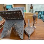 An Indian carved Koran stand together with a similarly decorated bellows and a table lamp