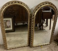 A set of five gilt framed wall mirrors of domed form with pierced borders