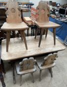 A pine kitchen table together with four pine dining chairs