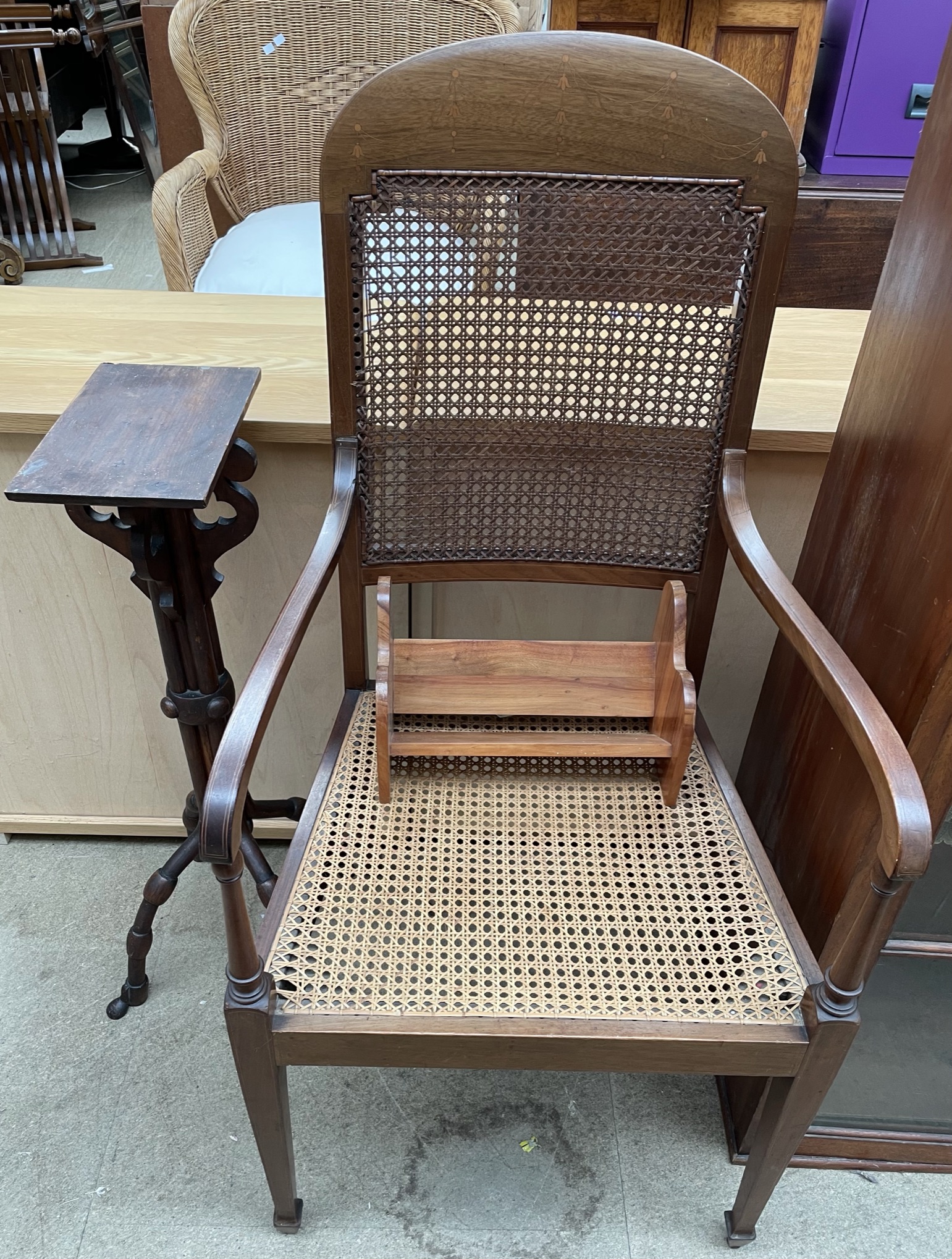 A bergere elbow chair together with a book rest,