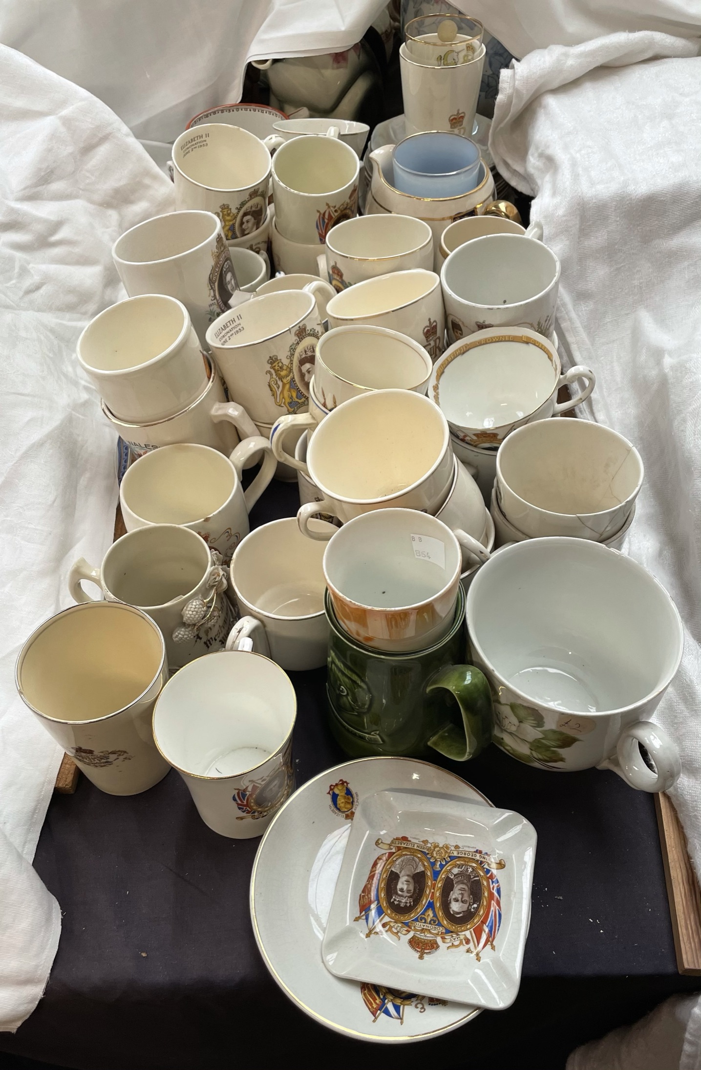 A collection of commemorative mugs etc