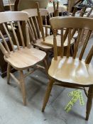 A set of six slat back kitchen dining chairs with solid seats on turned legs