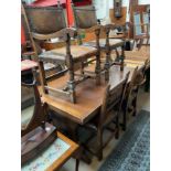 A 20th century oak extending dining table with carved and painted decoration,