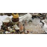 A cut glass bowl together with a decanter, assorted drinking glasses, decorative figures,