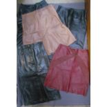Three leather skirts by Betty Jackson, (a long black, size 10, a knee length dark red and a tan,