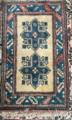 A cream ground rug with blue cross decoration and blue guard stripes,