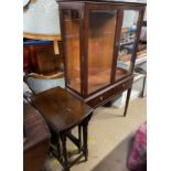 A reproduction mahogany display cabinet with a rectangular moulded top above glazed doors and sides,