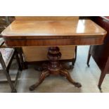 A Victorian mahogany card table the rectangular hinged top with rounded corner with a baize