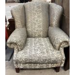 A George III style wing back upholstered arm chair on square legs