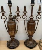 A pair of twin handled urn shaped table lamps with bronze effect decoration