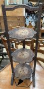 An Anglo Indian carved and brass inlaid folding cake stand