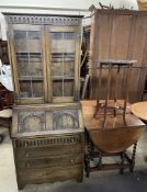 A 20th century oak bureau bookcase together with an oak gateleg dining table and a carved