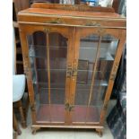 A 20th century walnut chinoiserie decorated display cabinet,