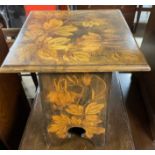 An Art Nouveau inspired occasional table with pen work decoration of flowers and fruits