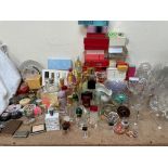 A collection of perfume bottles together with glass vases, glass sundae dishes, paperweights,