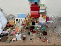 A collection of perfume bottles together with glass vases, glass sundae dishes, paperweights,