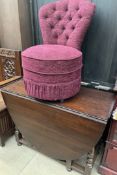 A 20th century oak gateleg dining table together with an upholstered tub chair