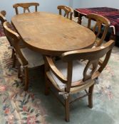 A modern extending dining table together with six chairs