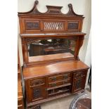 An Edwardian walnut mirrorback sideboard, with a carved cresting, shelf and arched mirror,