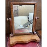A Victorian mahogany framed toilet mirror with a serpentine base