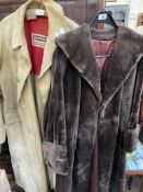 A faux fur coat together with another jacket