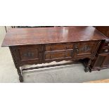 A 20th century oak sideboard with a rectangular top above a pair of central drawers and cupboards