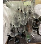 A collection of drinking glasses with black glass stems