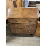A 19th century oak bureau, the sloping fall enclosing a fitted interior of pigeon holes and drawers,