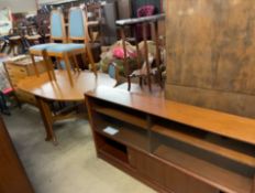 A teak bookcase with glazed doors together with a modern dining table and four chairs and a chest