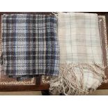 A tartan rug together with another rug