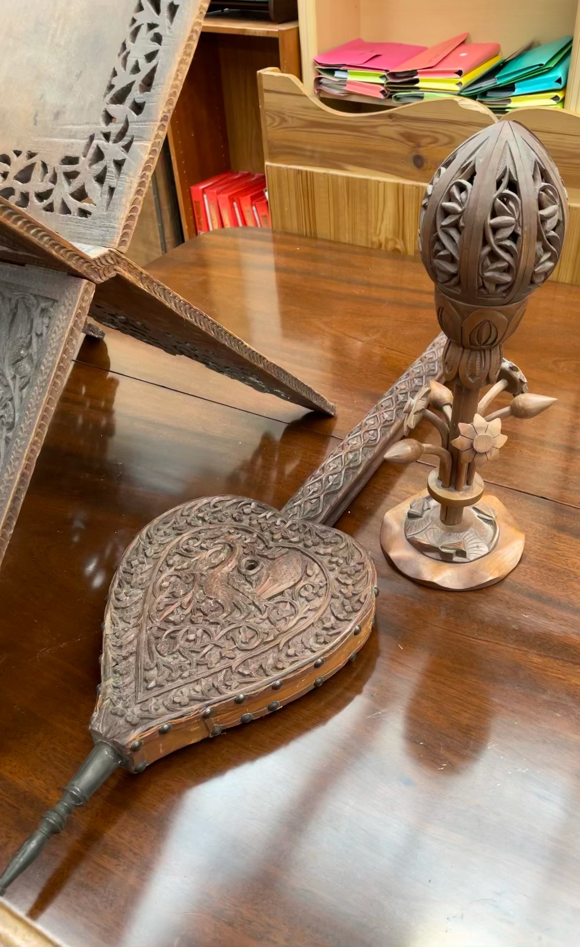 An Indian carved Koran stand together with a similarly decorated bellows and a table lamp