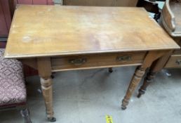 An Arts and Crafts style side table with a rectangular top above a frieze drawer on turned legs and