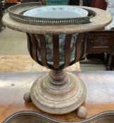 A 19th century mahogany jardiniere stand of urn shape with slatted sides a turned column and